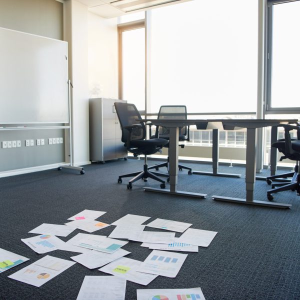 Business documents scattered on empty office floor