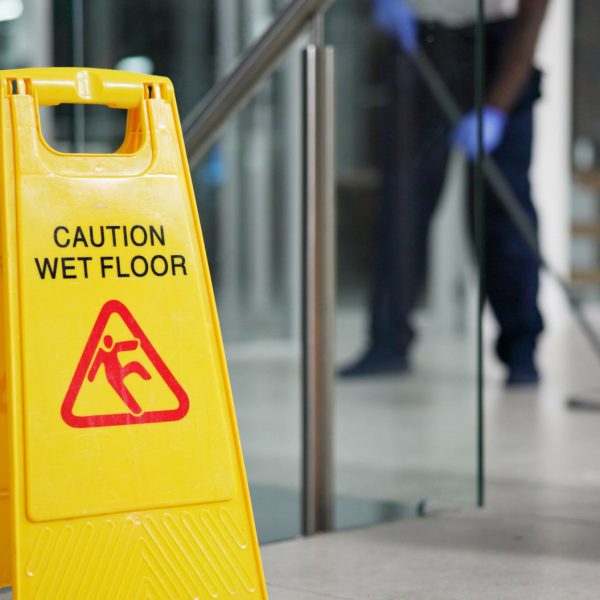 Caution, sign and cleaning for floor, janitor and hygiene service and dark at night in office. Mop,