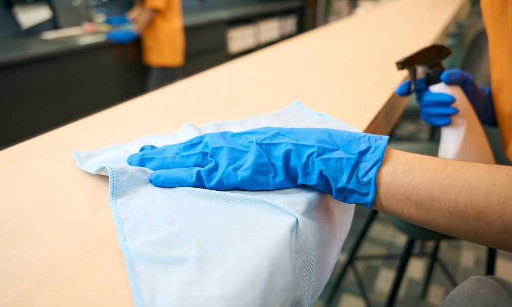 Cleaning company employees in uniform clean and disinfect surfaces