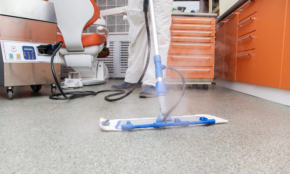 Young man cleans the floor in the dental office